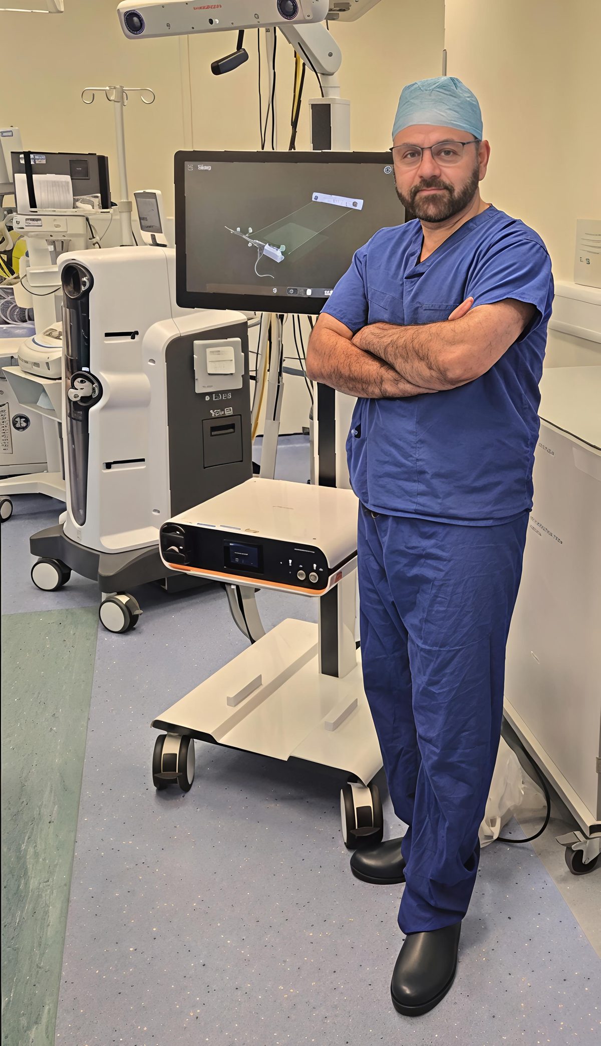 Mr Shakir Hussain, Consultant Orthopaedic Surgeon, with the CORI robotic knee replacement system in theatre, Birmingham