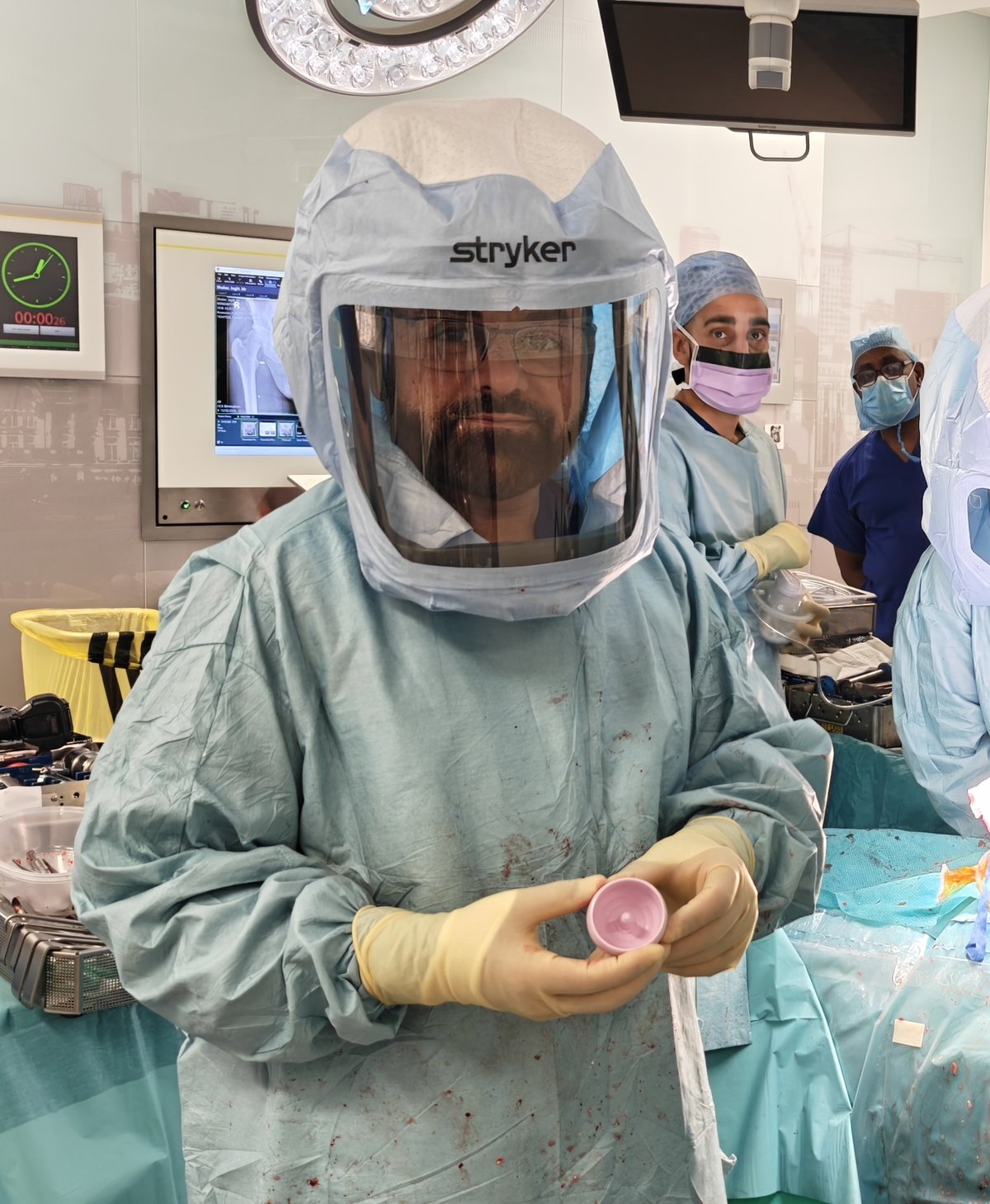 Mr Shakir Hussain holding the pink ReCerf ceramic-on-ceramic resurfacing cup at Harborne Hospital, Birmingham