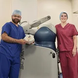 Mr Shakir Hussain with the MAKO surgical robot